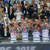 Rhinos captain Kevin Sinfield and Jamie Jones Buchanan, who missed the final through injury, lift the Challenge Cup.
