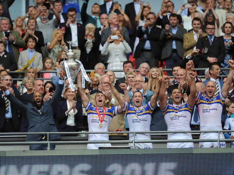 Rhinos captain Kevin Sinfield and Jamie Jones Buchanan, who missed the final through injury, lift the Challenge Cup.