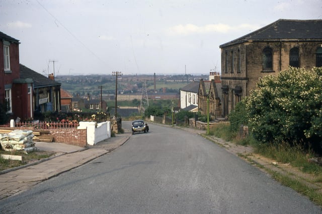 Back Green looking north-east in July 1968. W.L. Ingle Ltd. - Millshaw Leather Works is visible in the distance. On the left was the village institute under the supervision of Back Green Methodist Chapel. It was equipped for the playing of snooker and billiards. The site later became a builder's yard.