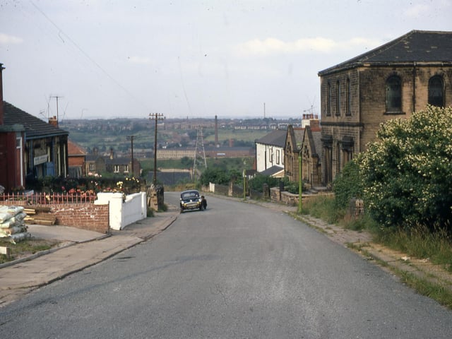 Back Green looking north-east in July 1968. W.L. Ingle Ltd. - Millshaw Leather Works is visible in the distance. On the left was the village institute under the supervision of Back Green Methodist Chapel. It was equipped for the playing of snooker and billiards. The site later became a builder's yard.