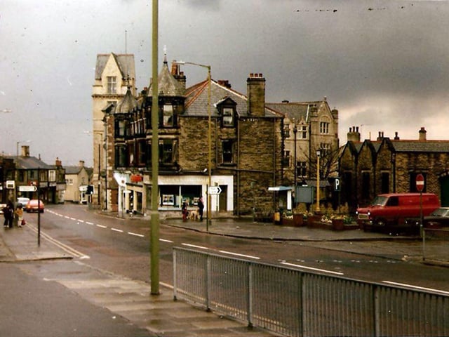 Pudsey Town Centre with Pudsey Town Hall in the background. On the right is Market Place, now the site of the new bus station. Running through the centre of the image is Church Lane.