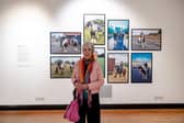 Photographer Cath Muldowney in Cartwright Hall Gallery in front of a selection of her photographs