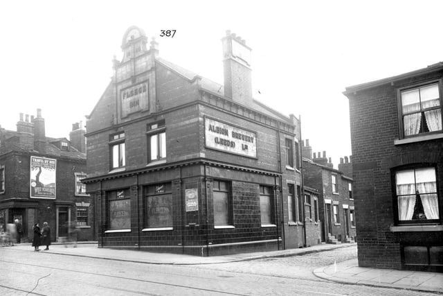The Fleece Inn between Vincent Street to the left and Plaid Row to the right in September 1935. At this time the licensee was Mrs Mary Tordoff. To the left is a travel poster Travel By Bus West Yorkshire Road Car Co. Ltd.