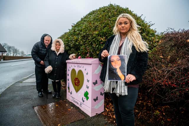Parents David and Karen Wilson, with their daughter Laura Wilson, next to their pink memorial box near Moortown Social Club in Cranmer Gardens.. The memorial box honours Victoria 'Tori' Wilson, who died in a tragic car crash in Thorner in 2020. Photo: James Hardisty