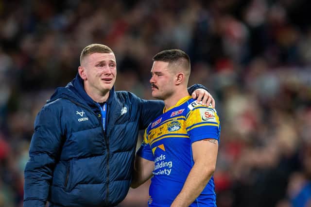 Harry Newman, who missed the Grand Final through injury, is consoled by Rhinos teammate James Bentley. Picture by Bruce Rollinson.