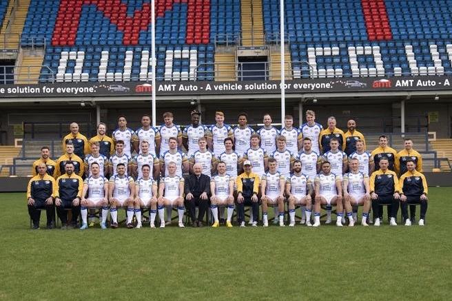 Chairman Paul Caddick joins Leeds Rhinos' players on their pre-season team picture.