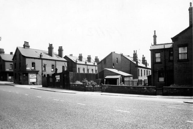 Looking south-east across Burley Road towards Cross Greenhow Avenue (on the left), where painters A. Woodhouse & Sons is on the corner. Pictured in July 1953.
