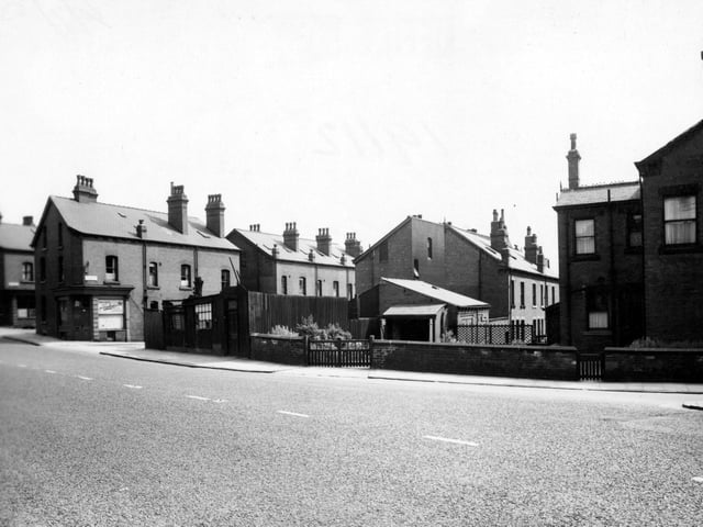 Looking south-east across Burley Road towards Cross Greenhow Avenue (on the left), where painters A. Woodhouse & Sons is on the corner. Pictured in July 1953.
