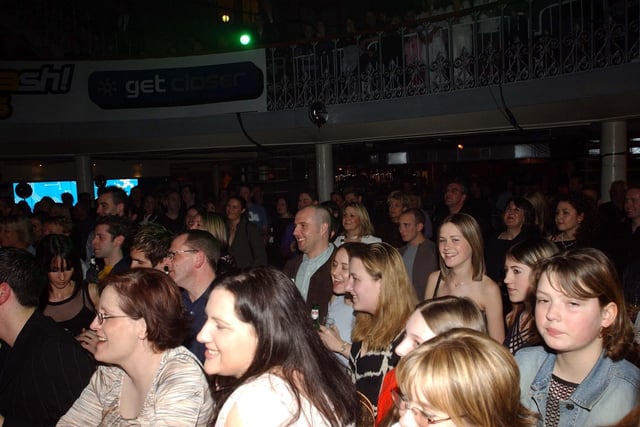 Fans watch on as Mel C performs at the Corn Exchange in Leeds city centre on March 22, 2003.