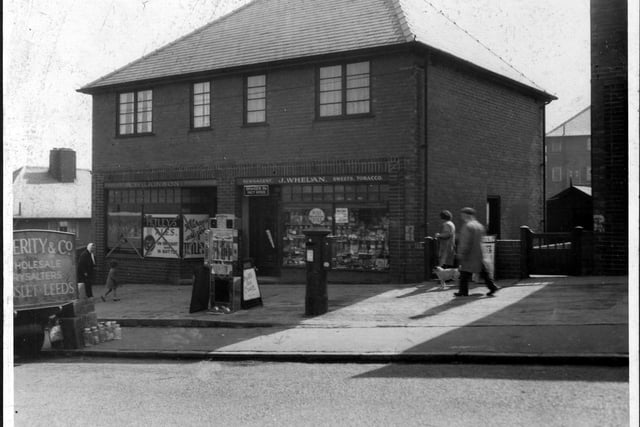 Two modern shops on Brander Road pictured in April 1939. The shop on the right is J. Whelan, newsagent and tobacconist, it is also a Post Office. The shop on the right is A. Wilkinson's Grocers.