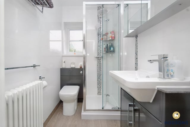 A ground floor shower room with vanity units.