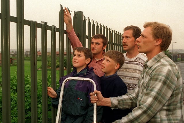 Looking at the seven foot high barbed railings at Richmond Hill Primary School on which seven-year-old Jason Jones became impaled in May 1996 his rescuers, from left, Simon Brooke, Steve Franks and Paul Stott together with Jason's brother Sean Jones, on right, and cousin Wesley Brattley.