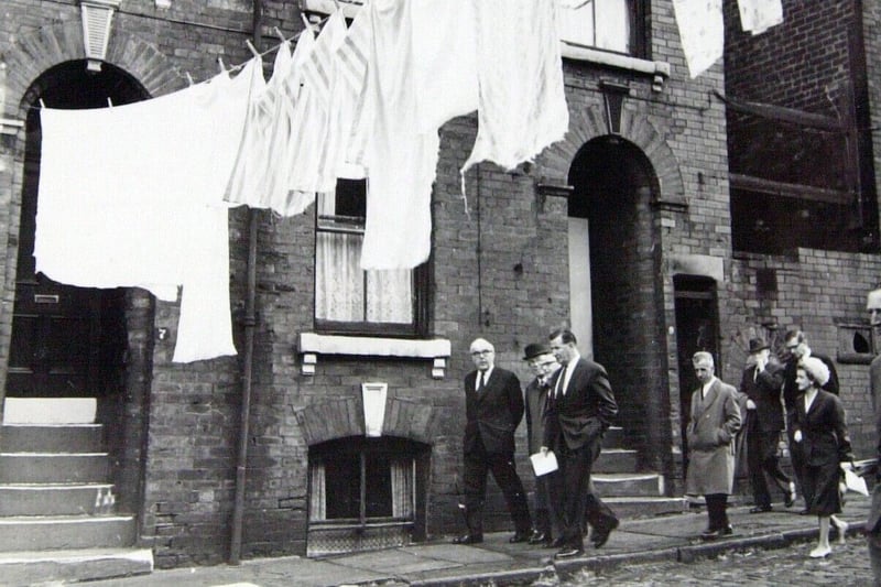 Minister for Housoing and Local Government, Rt Hon Dr Charles Hill MP, is pictured inspecting slums in Burmantofts in July 1962.