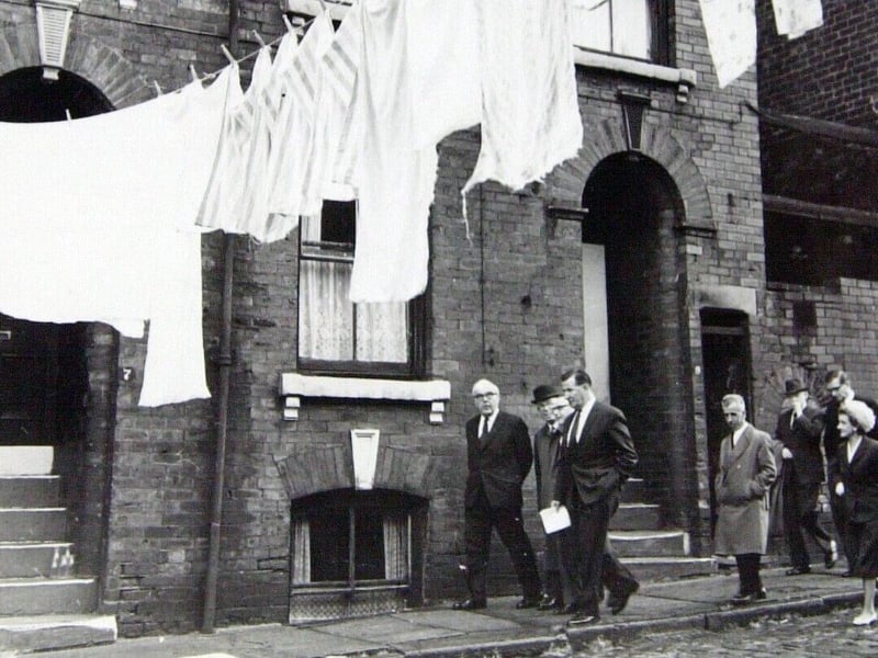 Minister for Housoing and Local Government, Rt Hon Dr Charles Hill MP, is pictured inspecting slums in Burmantofts in July 1962.