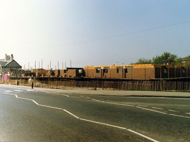 Selby Road showing the construction site for the new Halton Branch Library, part of a £1 million shopping centre development. The new library would soon replace the old branch which is still standing on the left of the picture, in front of the Travellers Inn public house. Pictured in April 1987.