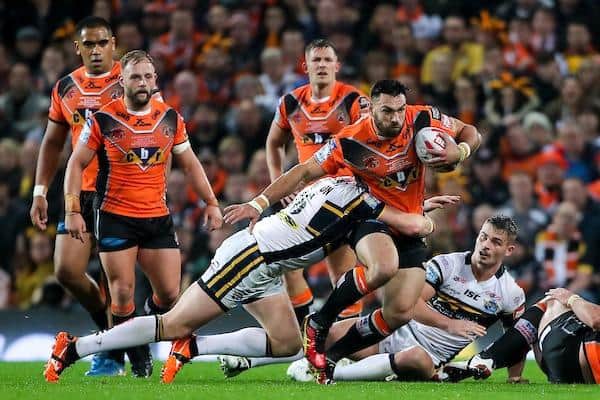 Matt Cook, of Castleford, is tackled by Leeds' Brad Singleton during the 2017 Grand Final. Picture by Alex Whitehead/SWpix.com.