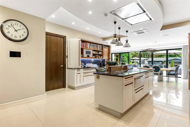 The stunning bespoke dining kitchen features a sitting room with concertina doors leading onto a large rear terrace.
