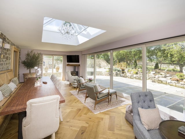 Light floods in to this large and modern dining room with sliding doors to an outdoor patio area.