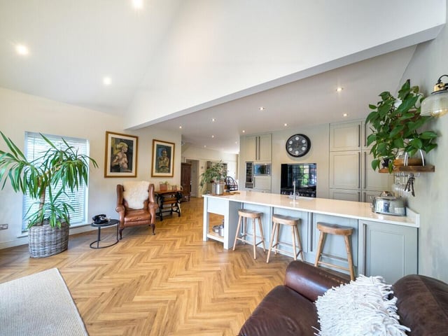 Upon entering the property, there is a spacious open plan kitchen, dining, and living space that forms the heart of the home.