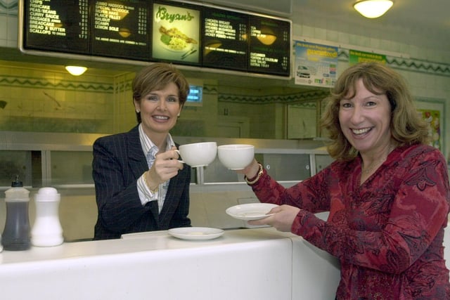 Enjoying a coffee as part of the 'World's Biggest Coffee Morning' in aid of Macmillan Nurses is Jan Fletcher, left, the owner of Bryans Fish Restaurant, and Kay Mellor, writer and actress, at Bryans where a coffee morning was held on September 26, 2003.