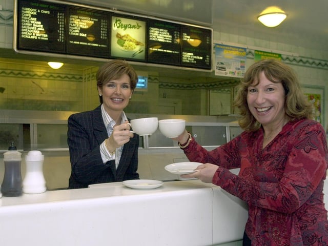 Enjoying a coffee as part of the 'World's Biggest Coffee Morning' in aid of Macmillan Nurses is Jan Fletcher, left, the owner of Bryans Fish Restaurant, and Kay Mellor, writer and actress, at Bryans where a coffee morning was held on September 26, 2003.