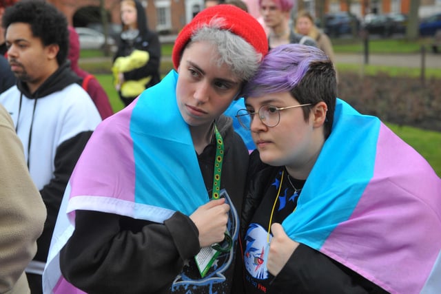 Two of the hundreds of people who turned out for the vigil in City Square, Leeds. Draped around their shoulders is the transgender flag, with its distinctive blue, white and pink stripes.