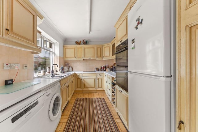 The kitchen features a double oven, halogen hob, dishwasher, wine rack, fridge, separate freezer and also plenty of cupboard space and storage for all utility essentials. A door lets out to the rear terrace.