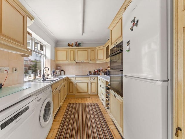 The kitchen features a double oven, halogen hob, dishwasher, wine rack, fridge, separate freezer and also plenty of cupboard space and storage for all utility essentials. A door lets out to the rear terrace.