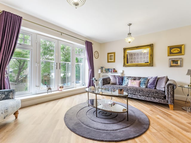 The living room is on the first floor and opens up onto a juliette balcony, ideal for looking out over the grounds during the summer months.