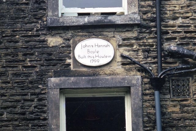 The exterior wall of Boyle Hall, located off Haigh Moor Road in July 1971. The plaque between the central windows of the first and second storey reads 'John & Hannah Boyle built this house in 1799'. The walls are constructed in hammer - dressed stone.