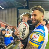 Andy Ackers and his young son celebrate after Leeds Rhinos' win at Leigh Leopards. Picture by Olly Hassell/SWpix.com.