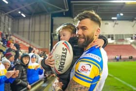 Andy Ackers and his young son celebrate after Leeds Rhinos' win at Leigh Leopards. Picture by Olly Hassell/SWpix.com.