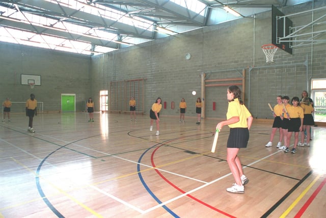 Pupils play rounders in the new school gym in September 2000.