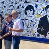 Paul Reaney, Paul Trevillion, Nicolas Dixon and Allan Clarke hold the FA Cup in front of the new mural.