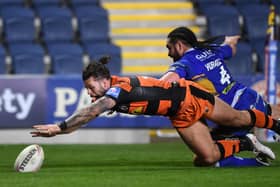 Alex Foster dives past Konrad Hurrell to score for Castleford against Rhinos at Headingley in 2019.
Picture by Jonathan Gawthorpe.