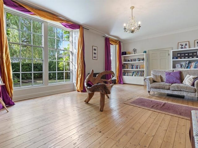 A generously sized room offers flexible living space, filled with natural light and the potential to suit a variety of uses.
