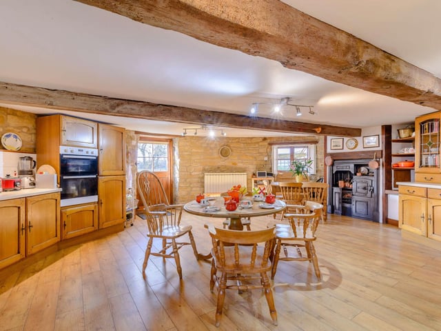 The first floor breakfast kitchen has an original cast iron oven and stove top, with wood units and integrated appliances.