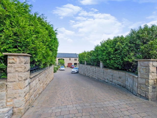 The private driveway leads in to the front courtyard.