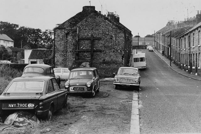Lickley, shored up house end which residents were complaining was an eyesore in September 1974.