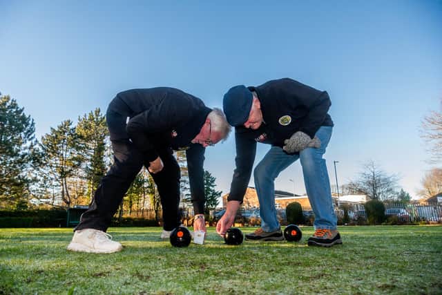 Gildersome Crown Green Bowling Club members Graham Gaunt and Harvey Lockwood, checking the distance of each bowling ball to the jack. Picture By Yorkshire Post Photographer,  James Hardisty.