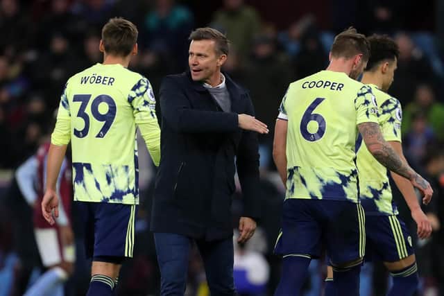 Leeds United's US head coach Jesse Marsch (C) consoles his players after the English Premier League football match between Aston Villa and Leeds Utd at Villa Park (Photo by GEOFF CADDICK/AFP via Getty Images)