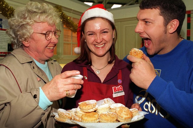 Mince pies and coffee were provided at B &Q on York Road  for the over 60s in the run up  to Christmas in December 1996. And Leeds RL players joined in the festivities. Pictured are Hilda Walker with Leeds player Barrie McDermott and Jo Sumnall, a B&Q management trainee.