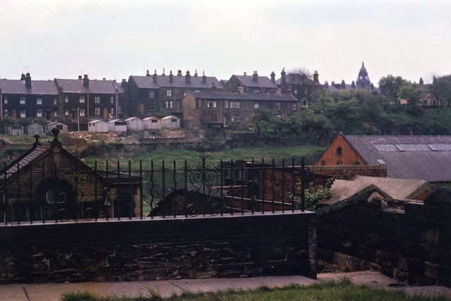 Troy Road from the grounds of Banks Hill Methodist Chapel in May 1963. The valley in between these two places is obscured but the roof of Perseverance Mill on Station Road can just be seen. The oldest houses on Troy Road are closest to the camera. Other older ones demolished here have the foundations used for standing the garages on. The houses at the other side of the road are typical 1890s stone houses which look like back-to-backs. The Town Hall is visible over the top of the St. Mary's-in-the-Wood churchyard.