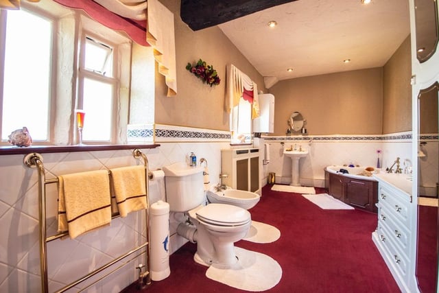 This bathroom suite includes a corner bath and a bidet.