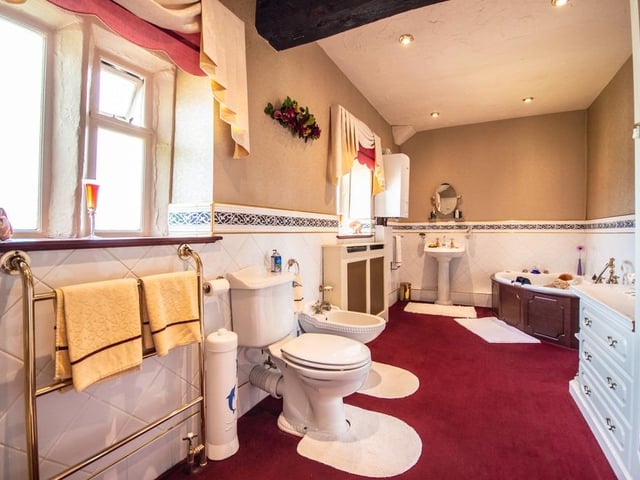 This bathroom suite includes a corner bath and a bidet.