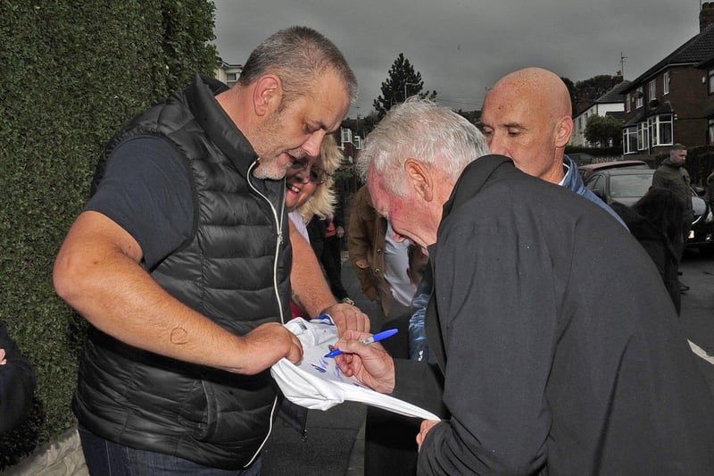 Pictured is Eddie Gray signing a shirt for a fan at the mural unveiling. Gray played a total of 579 games and 69 goals for the Whites and is now club ambassador for Leeds United.
