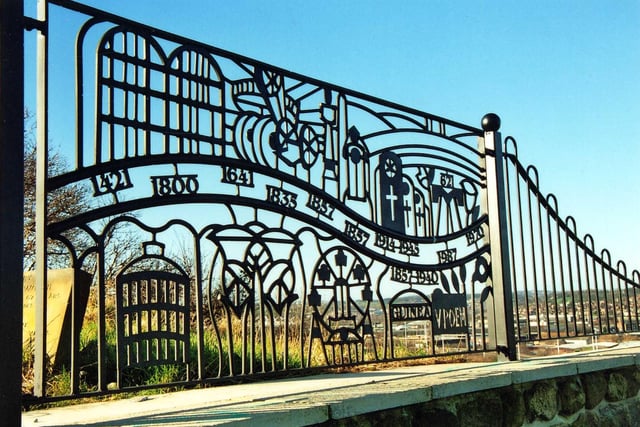 Decorative fencing put up at the viewing point in Holbeck Cemetery. It has significant dates including 1857 when the cemetery was first opened, 1857 - 1940 representing the era of the 'Guinea Graves'.