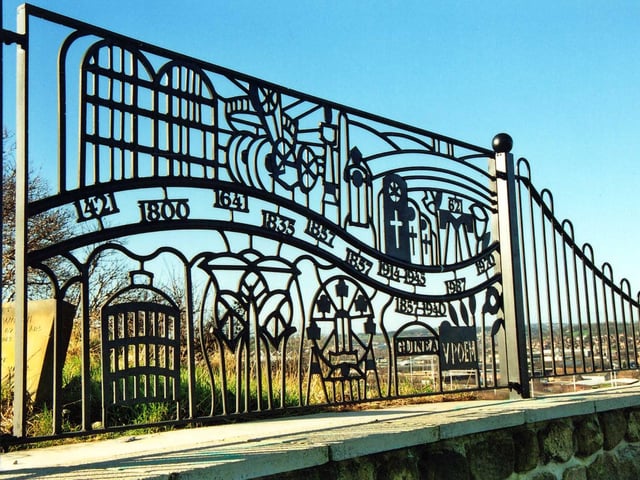 Decorative fencing put up at the viewing point in Holbeck Cemetery. It has significant dates including 1857 when the cemetery was first opened, 1857 - 1940 representing the era of the 'Guinea Graves'.