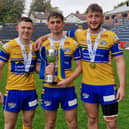 Elliott Fox, left, with teammates Harry Smith and Noah Whittingham following Rhinos' reserves Grand Final win against Warrington Wolves 13 months ago. Picture by Peter Smith.