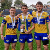 Elliott Fox, left, with teammates Harry Smith and Noah Whittingham following Rhinos' reserves Grand Final win against Warrington Wolves 13 months ago. Picture by Peter Smith.